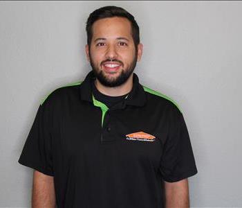 Male employee smiling with grey background